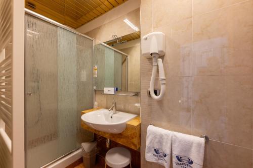 a bathroom with a sink and a mirror at Hotel Valentino in Terni
