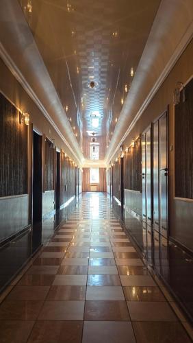 a hallway of a building with a tile floor at Ruben in Nowa Ruda