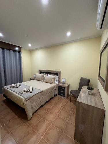 a bedroom with a large bed and a chair at Casa Os Baños in Bubaces