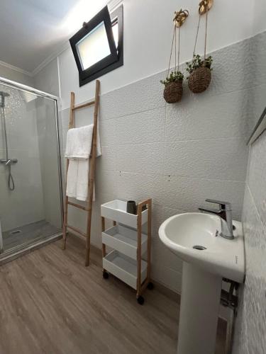 a bathroom with a sink and a shower at Funchal Casa in Funchal