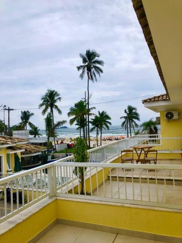 a balcony with a view of the beach at Jequitiba Hotel Frente ao Mar in Guarujá