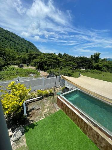 a swimming pool in the yard of a house at Puting Bakod- Vacation Home with Mountain & Lake View in Jalajala