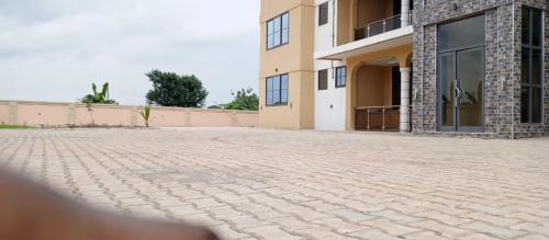 a brick driveway in front of a building at SMK Luxury Apartments Ho in Kodjobi