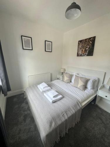 a bedroom with a bed with two towels on it at Simonside Apartment in Walker Gate