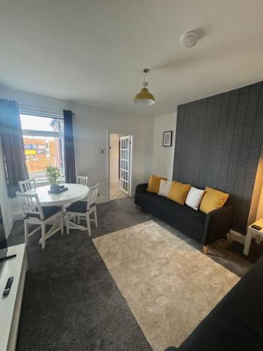 a living room with a couch and a table at Simonside Apartment in Walker Gate