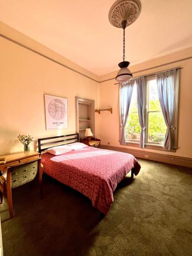 a bedroom with a bed and a large window at Northwest Portland Hostel in Portland