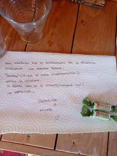 a piece of paper on top of a table at La casetta sotto l'albero LA CAROVANA GITANA in Vasto