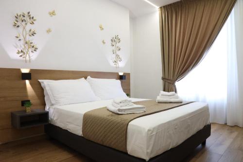 a bedroom with a bed with white sheets and a window at Palermo Centro Affittacamere Spina in Palermo