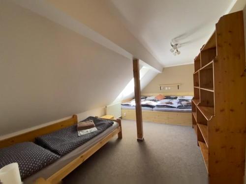 a bedroom with two beds and a bunk bed at Chalupa U brouka in Nová Bystřice