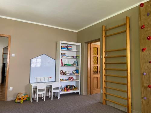 a room with a table and chairs and a mirror at Chalupa U brouka in Nová Bystřice