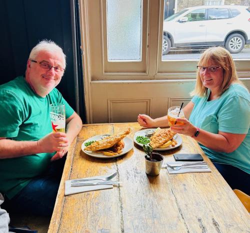a man and woman sitting at a table with plates of food at The Brookmill in London