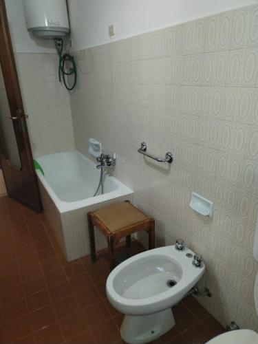 a bathroom with a toilet and a bath tub at Piccolo appartamento in montagna in Serina