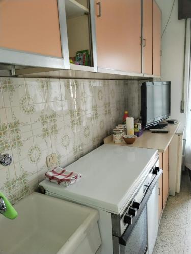 a kitchen with a white counter top and a stove at Piccolo appartamento in montagna in Serina