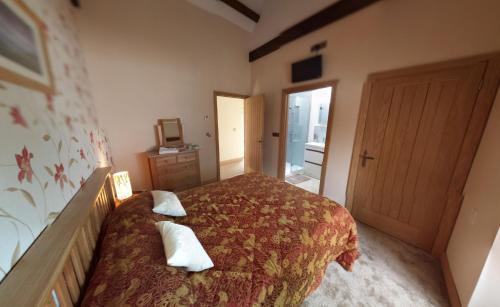 a bedroom with a bed with two pillows on it at Rhostwarch in Eglwyswrw