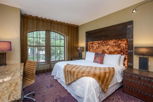 a bedroom with a large bed and a large window at Bohemian Hotel Savannah Riverfront, Autograph Collection in Savannah