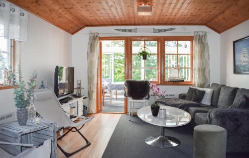 a living room with a couch and a table at Nice Home In Ronneby With Wifi in Ronneby
