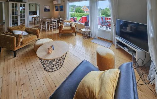 a living room with a couch and a tv at 3 Bedroom Beautiful Home In Tjøme in Tjøme