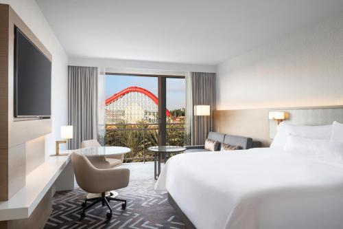 a hotel room with a bed and a roller coaster at The Westin Anaheim Resort in Anaheim