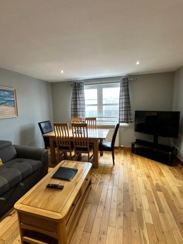 a living room with a couch and a table at Metro 8 Inverness City Centre in Inverness