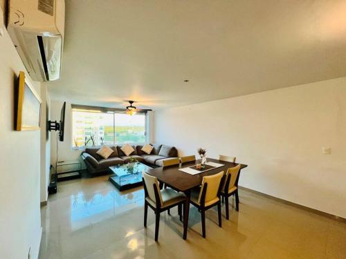 a living room with a table and chairs and a couch at Departamento la isla musala in Lima del Alto