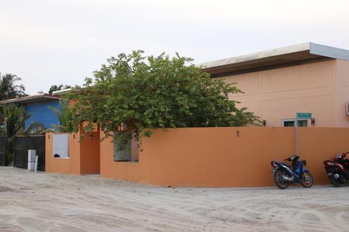 two motorcycles parked in front of a building at Samaik Orange in Hanimaadhoo