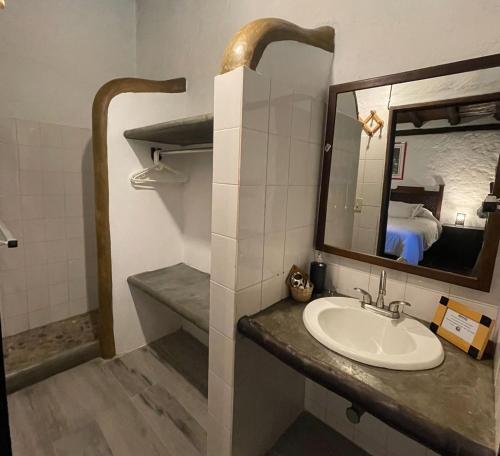 a bathroom with a sink and a mirror at Estancia La Cañada in Mérida