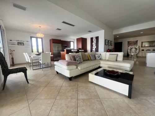 a living room with a couch and a table at Luxury Marina & Sea View Condo at Porto Cupecoy St Maarten in Lowlands