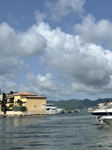 a river with houses and boats in the water at Luxury Marina & Sea View Condo at Porto Cupecoy St Maarten in Lowlands