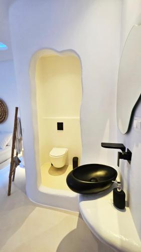 a bathroom with a toilet and a sink at ELLI TROPiCAL LUXURY SUITES SUNSET-INFINITY POOL- SEA SIDE-NEAR CENTER PARKING in Mikonos