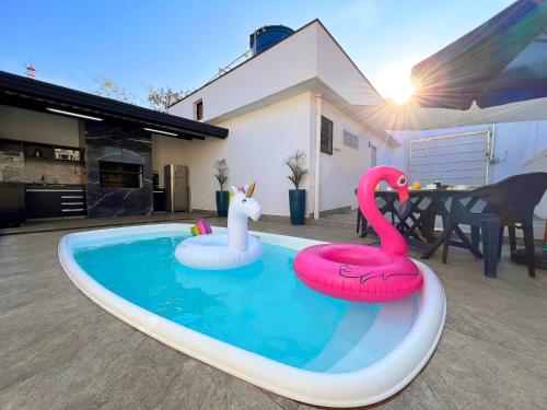 zwei aufblasbare Flamingos in einem Schwimmbad in einem Haus in der Unterkunft Casa Temporada Rio Quente (Em frente ao Hot Park) in Rio Quente