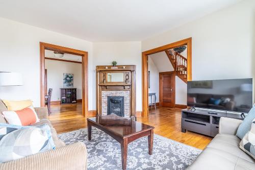 a living room with a couch and a fireplace at Charming Capitol Hill Craftsman in Seattle