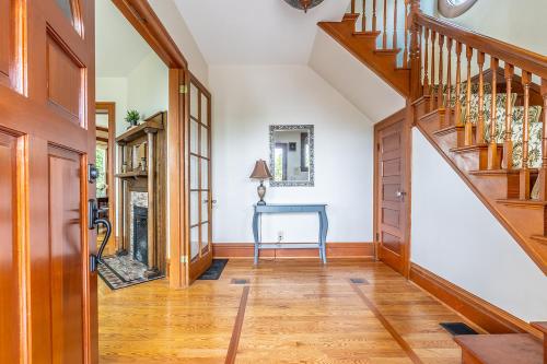 a hallway with a wooden staircase and a blue table at Charming Capitol Hill Craftsman in Seattle