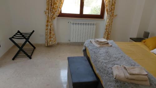 a bedroom with a bed and a couch and a window at Appartamento DAF House in Roccasecca
