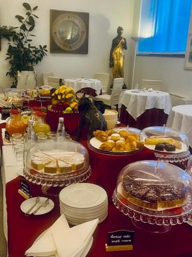 a table with many different types of food on it at Hotel La Nuova Rotaia in Gallarate