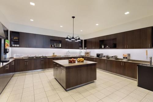 a large kitchen with wooden cabinets and a island at Residence Inn by Marriott Boston Back Bay/Fenway in Boston