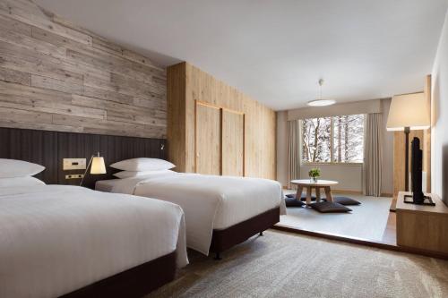 a hotel room with two beds and a window at Courtyard by Marriott Hakuba in Hakuba