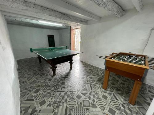 a room with a ping pong table and a pool table at Aroucanatur, Casa de Montanha in Arouca