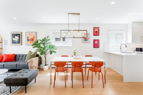 a kitchen and living room with a table and chairs at Riley Park-Modern 4 Bedroom Home, Central location in Vancouver