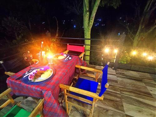 a table and chairs with a plate of food on it at Montelungo Cabañas Glamping in Chimbe