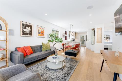 a living room with a couch and a table at Riley Park-Modern 4 Bedroom Home, Central location in Vancouver