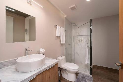 a bathroom with a sink and a toilet and a shower at Best view rooftop with heated jacuzzi in Cabo San Lucas