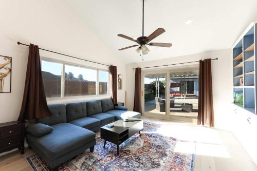 a living room with a couch and a ceiling fan at Pristine Poway Retreat in Poway
