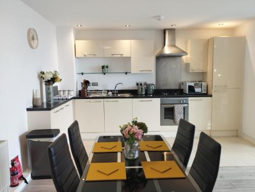 a kitchen with a dining room table and chairs at The Green Top flat with parking included amazing views and perfect location in Plymouth