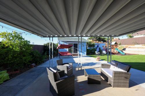 a patio with couches and chairs under a canopy at Pristine Poway Retreat in Poway