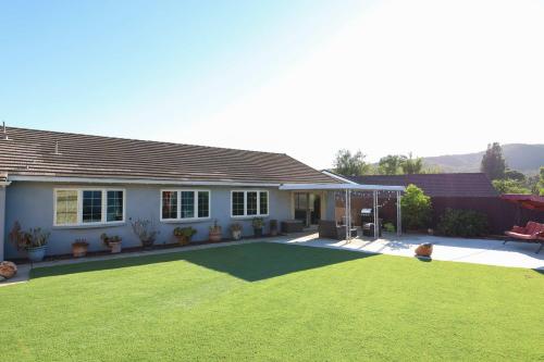 a house with a large lawn in front of it at Pristine Poway Retreat in Poway