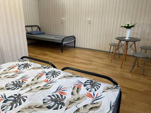 a room with a bed and a table with stools at VIP hostel in Mukacheve