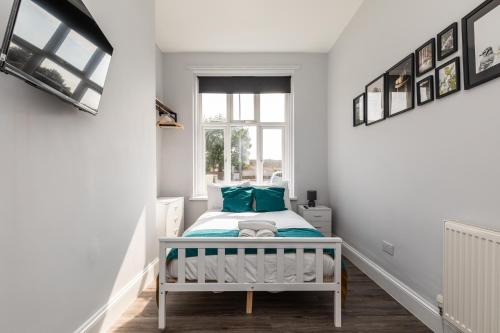 a small bedroom with a bed and a window at Dove Court Travel Lodge 1 - Ground Floor Ensuite in Bristol