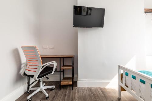 a bedroom with a desk and a chair and a bed at Dove Court Travel Lodge 1 - Ground Floor Ensuite in Bristol