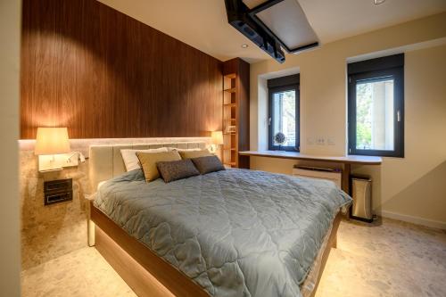 a bedroom with a bed and a tv on the wall at Modular Central Studio in Kotor