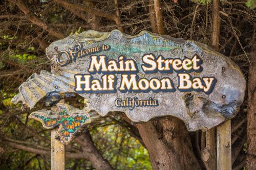 a sign for a main street half moon bay at Unmatched Ocean Beach and Mountain Views Family-Friendly Retreat in Moss Beach